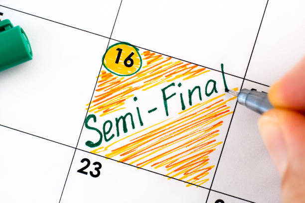 istock Person fingers with pen writing reminder Semi-Final in calendar 1344788549