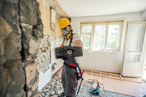 Worker using hammer, home renovation