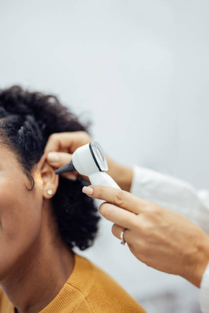 Close-up of a doctor doing ear examination on a patient. Close-up of a doctor doing ear examination on a patient. Using otoscope. ear drumm stock pictures, royalty-free photos & images