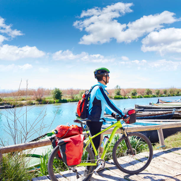 MTB Biker Bicycle touring on the river with pannier
