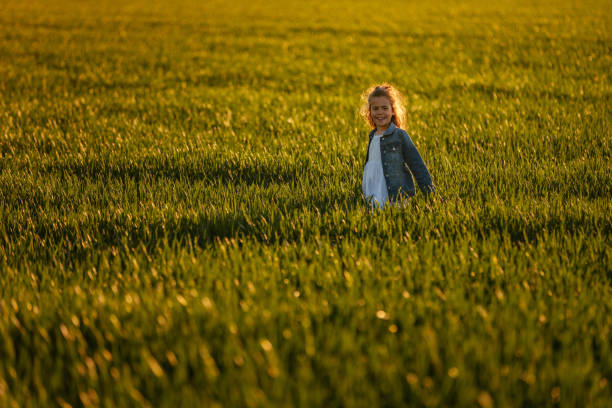 istock Little girl in the field 1344792478