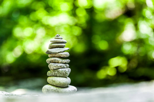 Cairn in forest against blurred green background