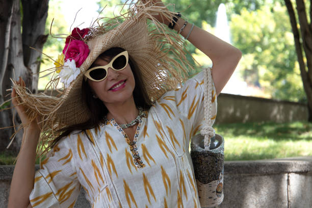 istock smiling woman putting on her hat 1344796445