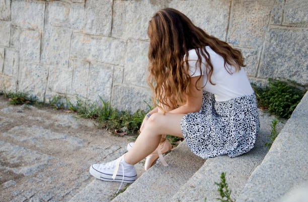 istock sitting teenager changing sneakers 1344796697