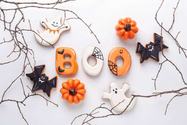 istock Text BOO from gingerbread cookies, Halloween decorations, bat on white background. Halloween concept 1344797405