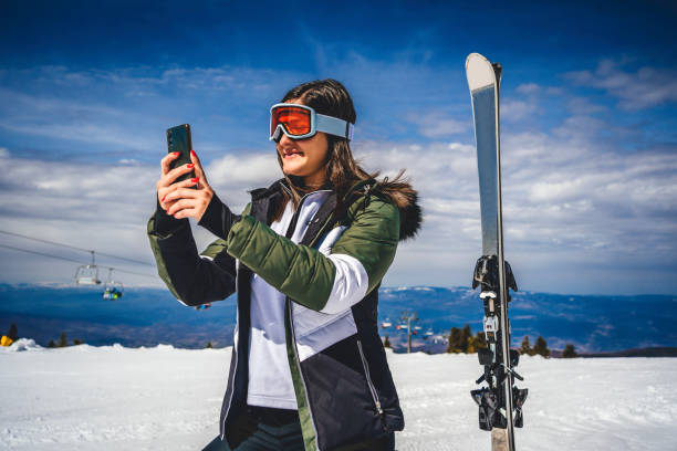 istock Female skier using mobile phone 1344797824