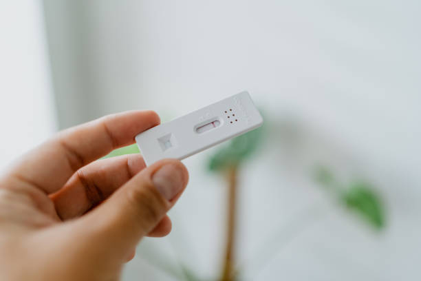 istock Man holding a Covid-19 rapid test device 1344799101
