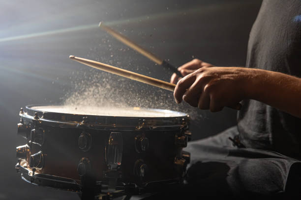 istock Close up drummer playing snare drum on dark background. 1344800166