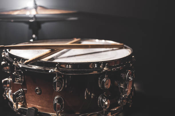 Part of a drum kit, snare drum on a dark background. Snare drum, percussion instrument on a dark background with stage lighting. drum percussion instrument photos stock pictures, royalty-free photos & images
