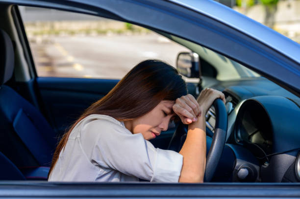 istock Stressed woman driver sitting inside her car 1344800686