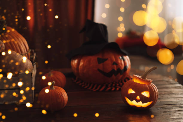istock Ready halloween pumpkins with faces jack-o-lantern and hat 1344800868