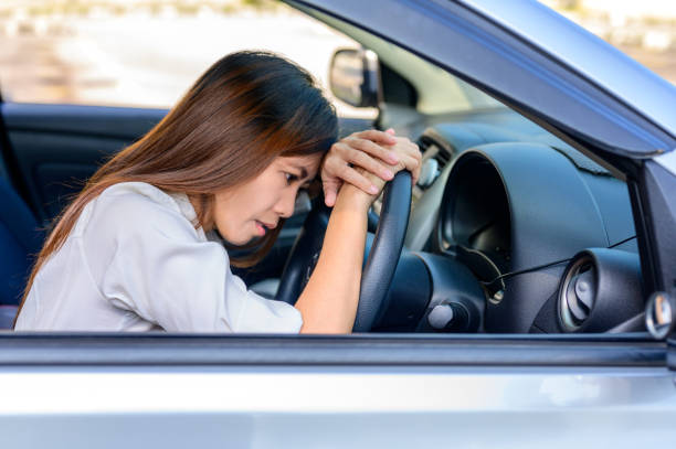 istock Stressed woman driver sitting inside her car 1344801759