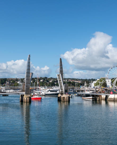 istock Yacht sails under Torquay lifting footbridge in harbour 1344802101