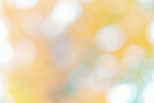 Abstract yellow warm colors background with bokeh defocused lights and shadow