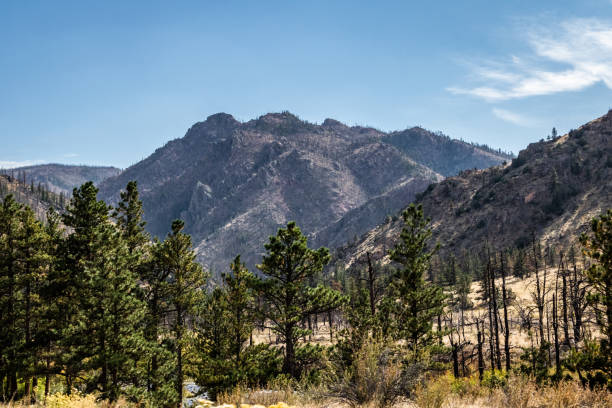 istock Blue skies over a bare mountain 1344803508