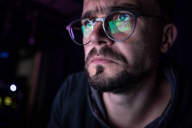 istock A man stares intently at a computer screen in the dark at night. 1344803654