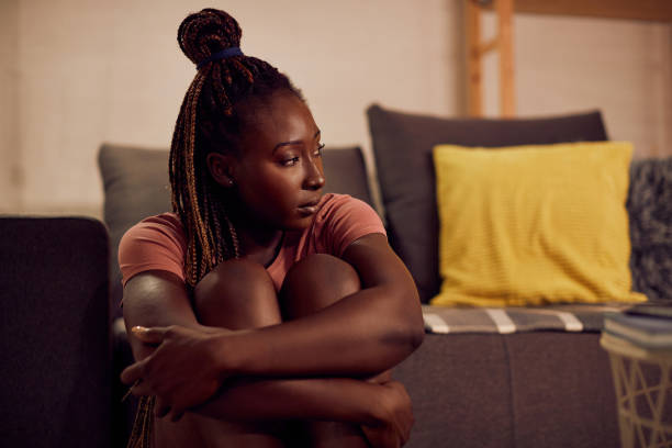 istock Young depressed black woman thinking of something while being alone at home. 1344803703