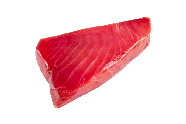 Yellow fin tuna steak isolated on white background. Fresh rare tuna steak isolated on white. Raw yellowfin tuna fillet texture. Backround fresh tuna meat. Top view of slices of tuna meat. stock photo