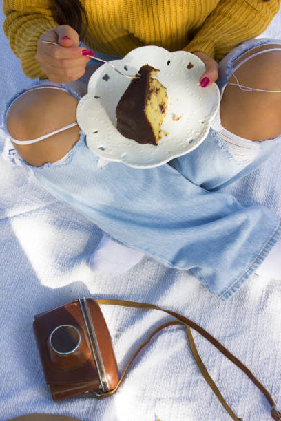 A Bundt cake with berries. Close-up. Vintage camera  and girl in background.