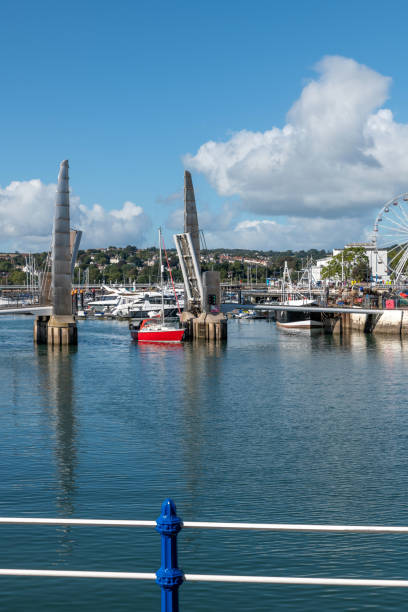 istock Yacht sails under Torquay lifting footbridge in harbour 1344806707