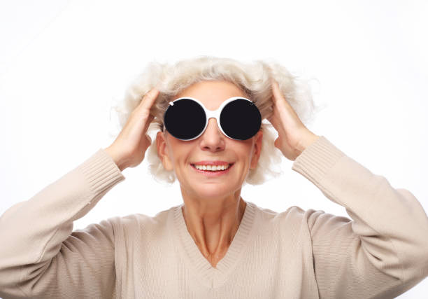 senior grey haired woman with big sunglasses over white