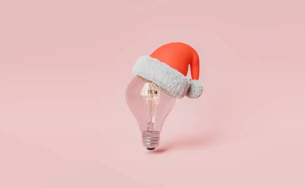 Photo of light bulb with christmas hat