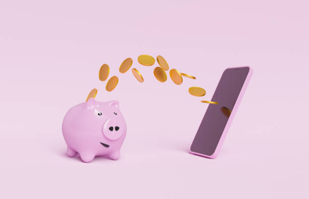 携帯電話に向かって飛んでコインと貯金箱 - piggy bank savings internet finance ストックフォトと画像