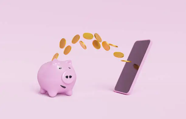 Photo of piggy bank with coins flying towards a mobile phone
