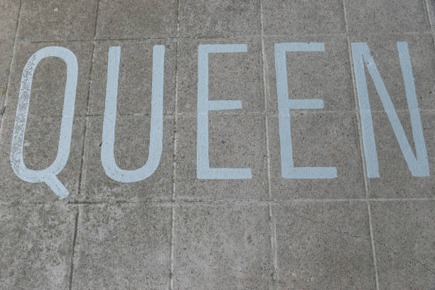 the word Queen written on a tiles floor