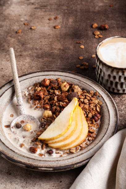 istock Chocolate granola with almond milk, pear and honey. 1344808830