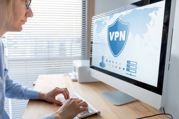 vpn secure connection for telecommuter. person using virtual private network technology on computer to create encrypted tunnel to remote server on internet to protect data privacy, home office. - computer software tunnel data technology imagens e fotografias de stock