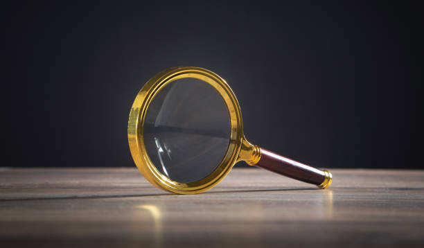 istock Magnifying glass on the wooden table. 1344810045