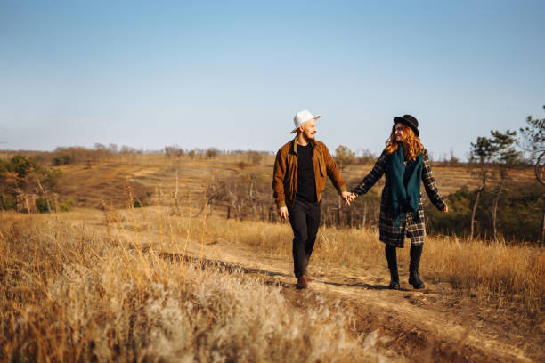 istock Young couple walking in the autumn park. 1344810135