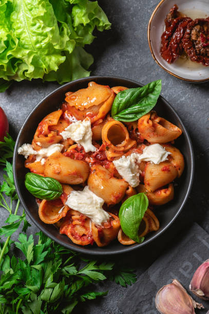 istock Italian pasta with mozzarella and fresh basil 1344810278