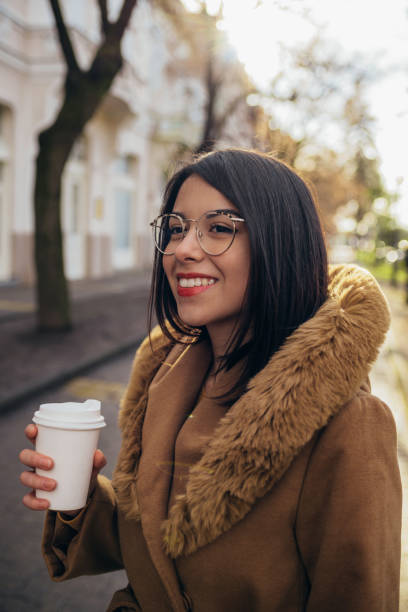 istock Young hispanic woman drinking coffee takeaway 1344814918