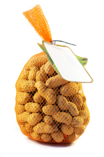 Peeled walnuts in the transparent plastic bag isolated on the white background with clipping path