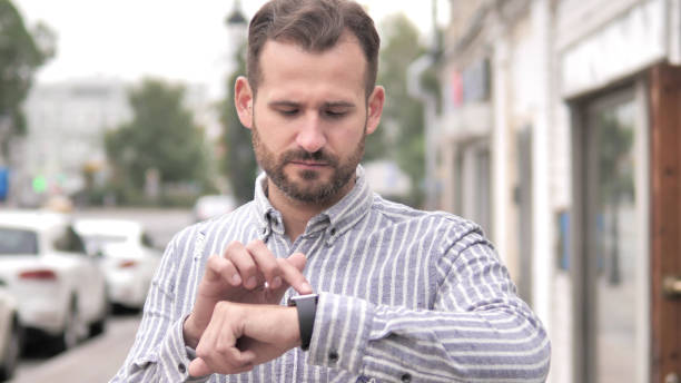 istock Beard Casual Man Using Smartwatch Outdoor 1344816500