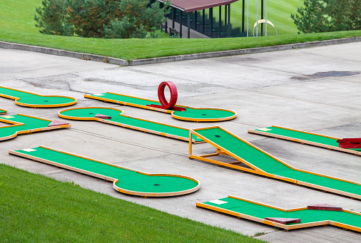 mini golf course for leisure and relaxation in green park. Fun fitness game recreation activity concept.