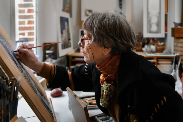 istock Senior Woman Working on Painting 1344817346