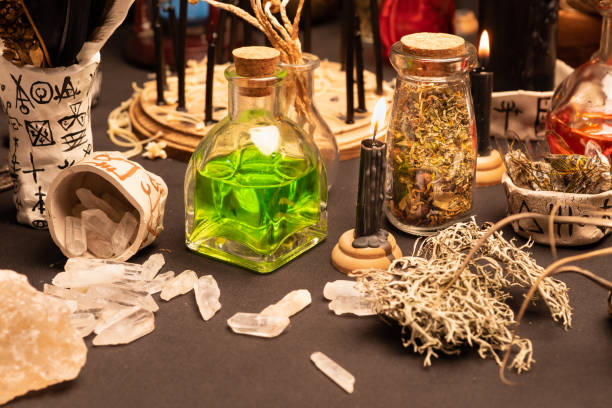 istock Witchcraft ceremony, selective focus at potion vial or glass bottle with magic liquid ingredient. Alchemy and esoteric items for magic cult at the background. Spiritual occultism and magic chemistry 1344818107