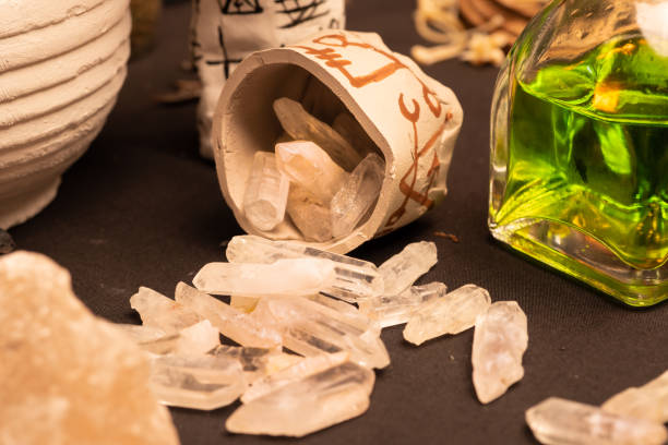 istock Witchcraft ceremony selective focus at magic crystal stones for alchemy and esoteric cult. Spiritual occultism and magic chemistry inspired by mysticism. Witch, warlock magician concept. Halloween. 1344818147