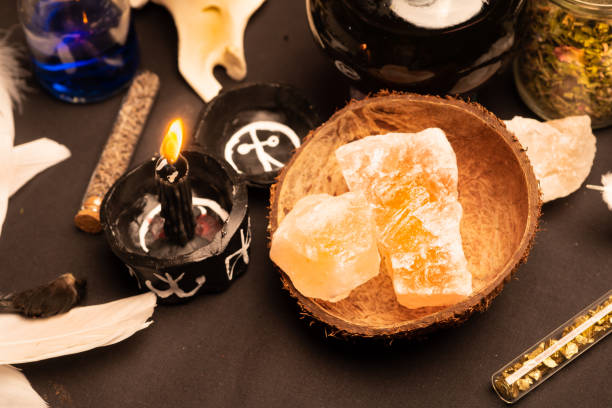 istock Witchcraft ceremony selective focus at magic crystal stones for alchemy and esoteric cult. Spiritual occultism and magic chemistry inspired by mysticism. Witch, warlock magician concept. Halloween. 1344818200