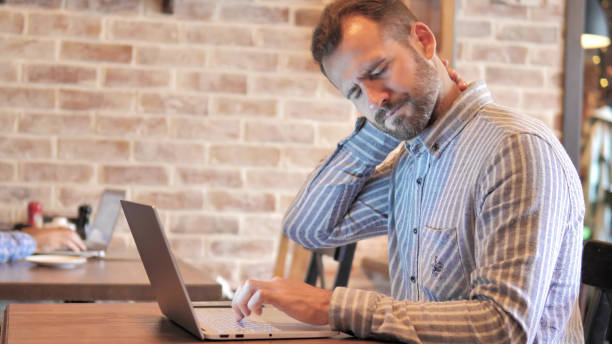 istock Beard Casual Man with Neck Pain Using Laptop 1344819342