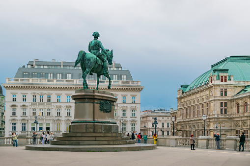 30 May 2019 Vienna, Austria - Statue Of Archduke Albrecht Outside Albertina Museum. Cloudy sky, Vienna State Opera(Wiener Staatsoper) on the background.