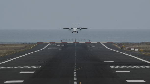 istock An airport runway with a landing plane 1344820666