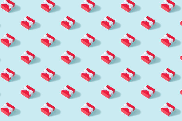 Creative Christmas isometric pattern made of red gift box on blue background. Minimal Christmas or New Year concept
