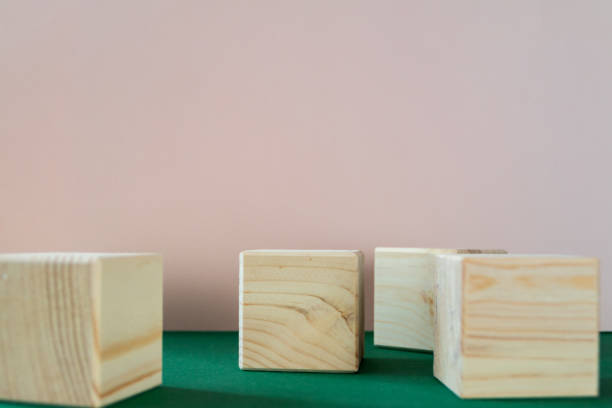 istock Wooden cubes on green background 1344820967