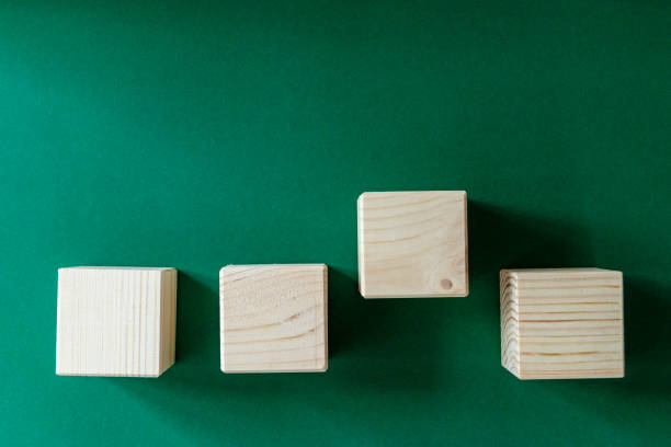 istock Wooden cubes on green background 1344821001
