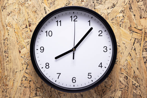 istock Clock watch on wood chipboard of wall surface background texture 1344821041