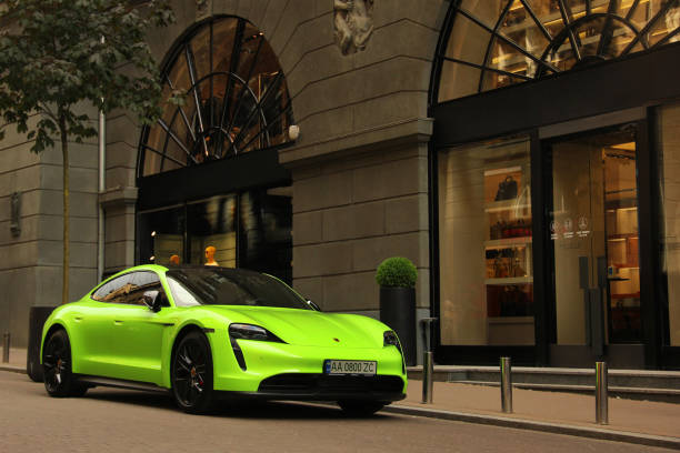 Matte Porsche Taycan Turbo S lime color in the city stock photo